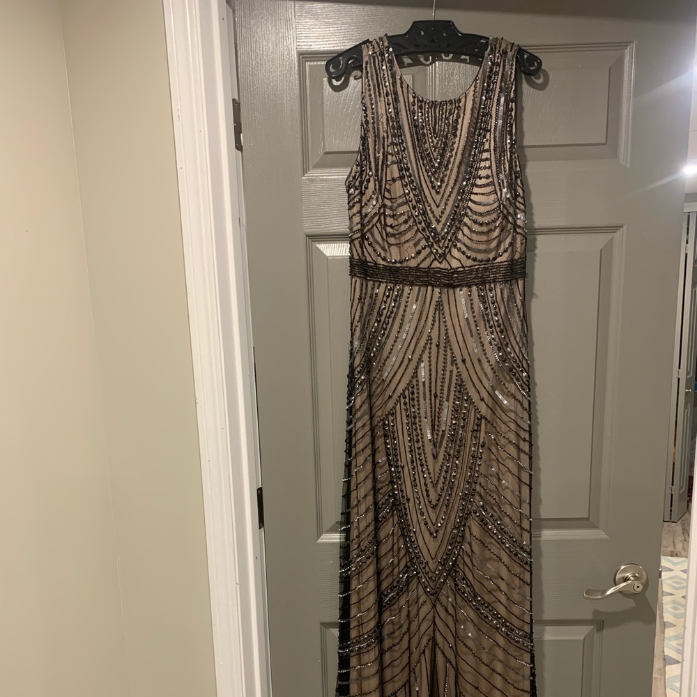 Black vintage beaded dress with nude lining. V back with zipper closure
